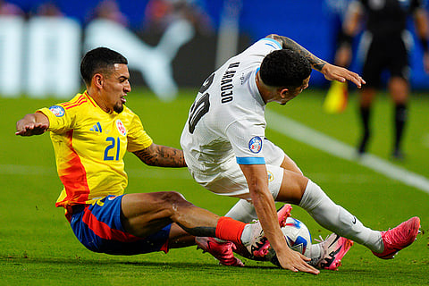 Daniel Munoz and Maximiliano Araujo battle for the ball